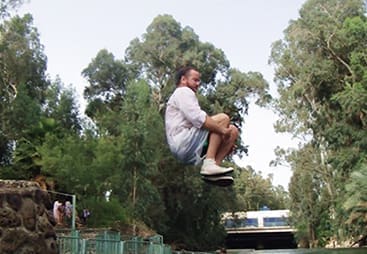 The author does a cannonball into the Jordan River to help illustrate his church