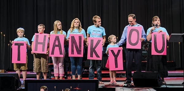 Matt and Katie Proctor and their six children, each wearing a 