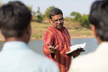 Ajai Lall baptizing in the river on Easter.
