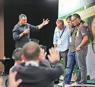 Greg Nettle prays for Los Angeles church planters at Exponential West 2013 in October.