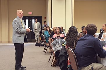 Point University President Dean Collins congratulates students from the Access adult program at their commencement ceremony on May 10. The ceremony was held at the New Hope Baptist Church