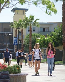 Students enjoy the sun while walking across campus at Hope International University, Fullerton, California.