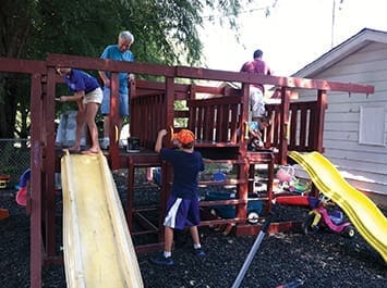 Volunteers from Tower Hill Christian Church help refurbish a playground at a nearby inner-city mission.