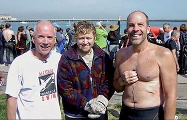 Stephen Bond (left) stands with swimming companions Charlene Wardlow and Ed Hendricks after the trio completed the 1.5-mile swim from Alcatraz to the San Francisco Aquatic Park.