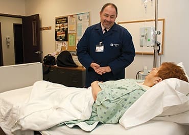 Chaplain Robert Henderson meets with a patient at Decatur Memorial Hospital.