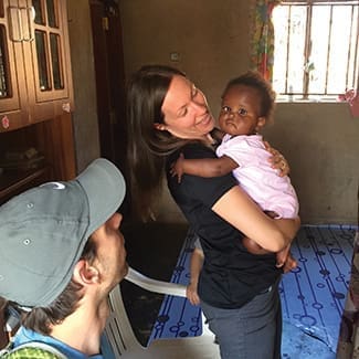 Amanda Bolen holds Favour for the first time, at the orphanage, on May 4, 2015, as husband Kirk looks on.