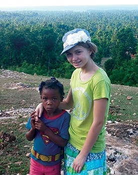 Kendall Kemerly with one of the girls who now has a sustainable living because of the poultry program.