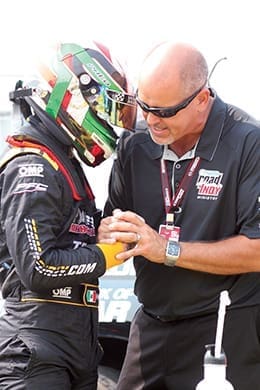 David Storvick, who serves with IndyCar Ministry, prays with Patricio O