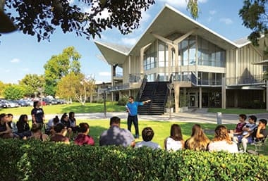 An instructor lectures outside the Hugh and Hazel Darling Library at Hope International University, Fullerton, California. The campus