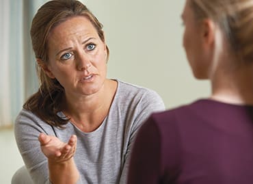 Mature Woman Discussing Problems With Counselor