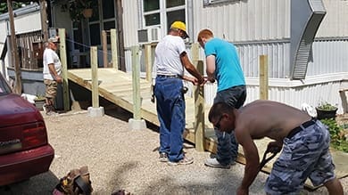 Volunteers with Missions for Taylorville install a wheelchair ramp as part of a multichurch home improvement ministry in that small city in central Illinois.