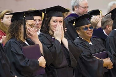 Students who are serving time at Tennessee Prison for Women tear up on their graduation day after praying a bit earlier. Lipscomb University
