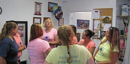 Volunteers at Guiding Light Goodies listen to a few of the girls quote that week
